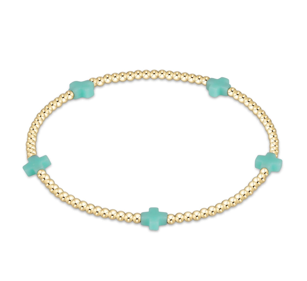 SIGNATURE CROSS SMALL GOLD PATTERN 2MM - MINT