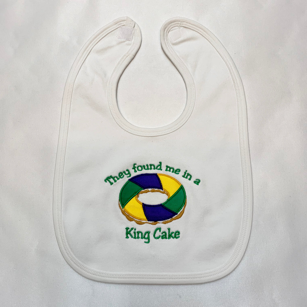 THEY FOUND ME IN A KING CAKE APPLIQUE BABY BIB